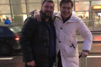 giorgi-siguam-da-saakaSvilma-varSavis-aeroportSi-fotokameris-win-ipoziores
